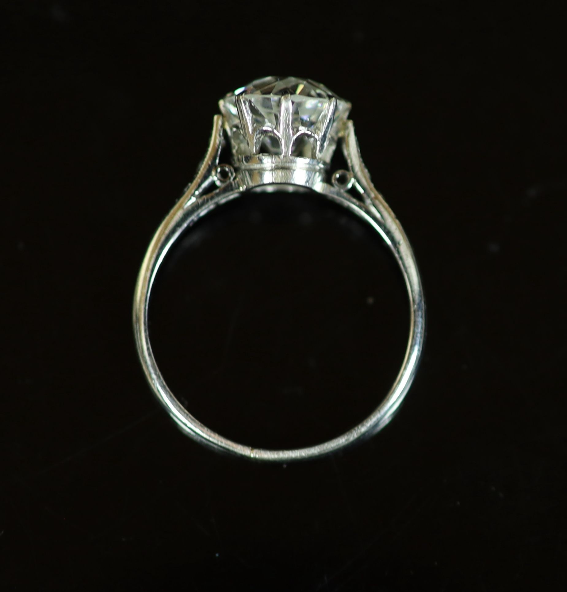 A platinum and single stone diamond ring, with diamond set shoulders